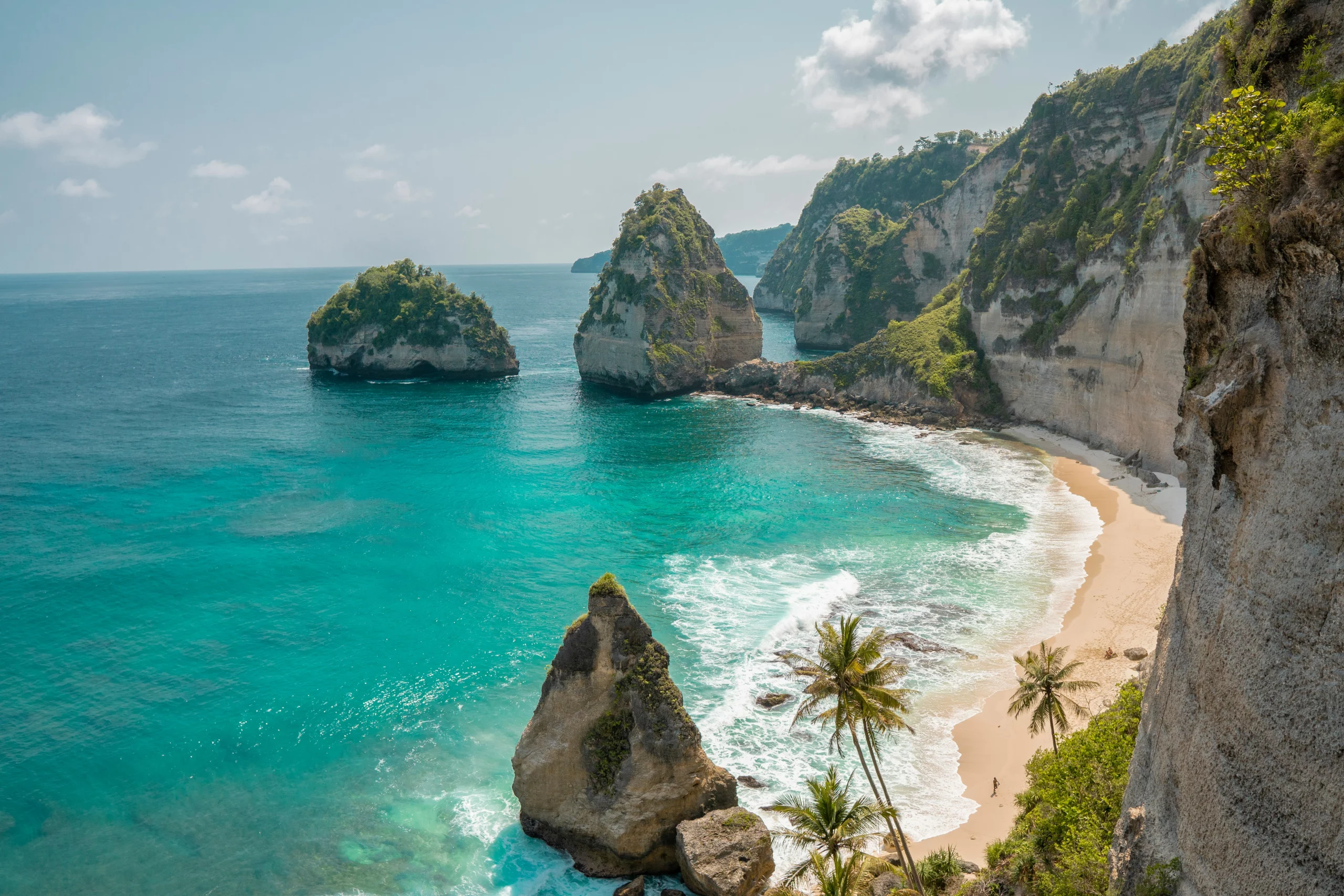 Voyage entre femmes en Indonésie : plage tropicale avec falaises calcaires et eaux turquoise – Salma Travel