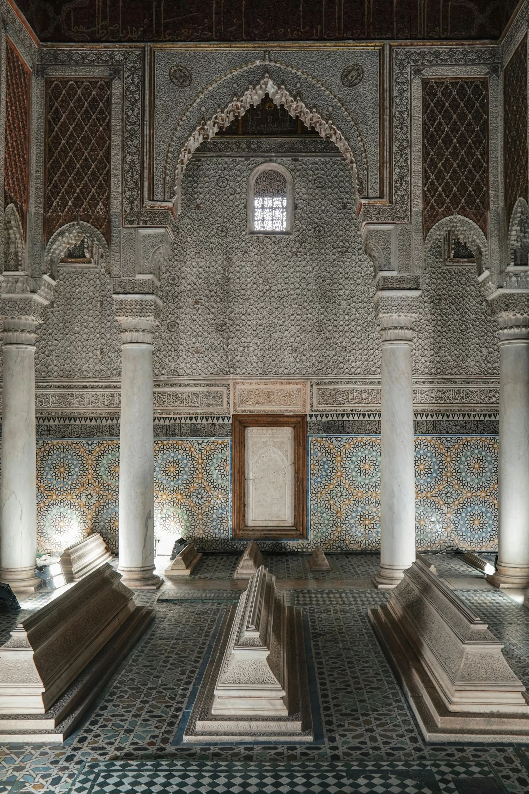 Voyage entre femmes au Maroc : intérieur d’un mausolée marocain décoré avec colonnes en marbre et tombeaux – Salma Travel